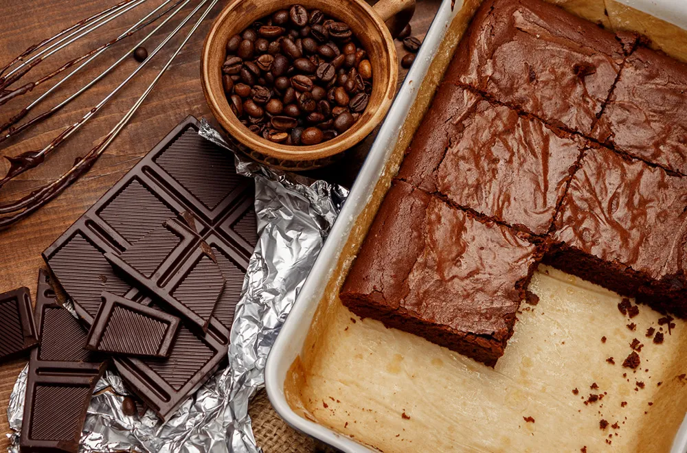 brownie pan, chocolate bar and cocoa seeds