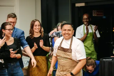Luis, the Baristar winner, smiling while people applaud